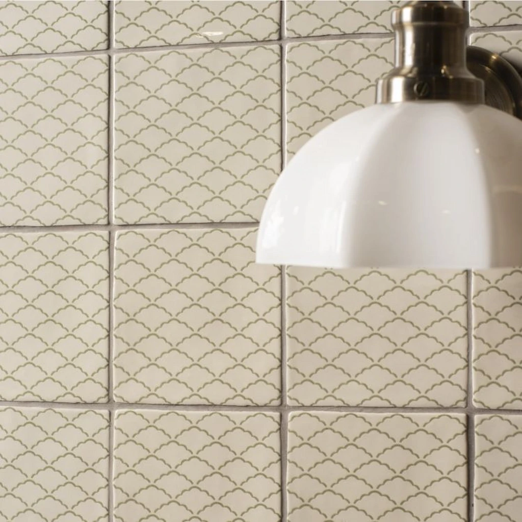 Nuage Pumice glazed ceramic wall tiles with a soft green cloud pattern on a warm off-white background.
