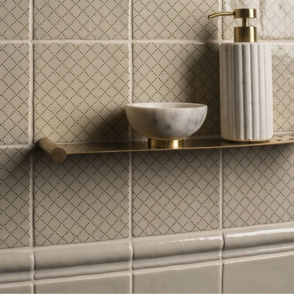 Manoir Deco Trellis patterned wall tiles in soft green on a pumice background, shown installed in a bathroom setting