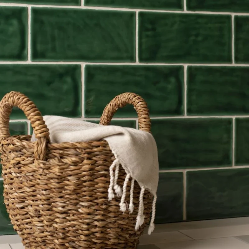 Tourmaline Brick Tile deep green glazed brick tiles with rich tonal variation and soft sheen, laid in a classic horizontal layout.