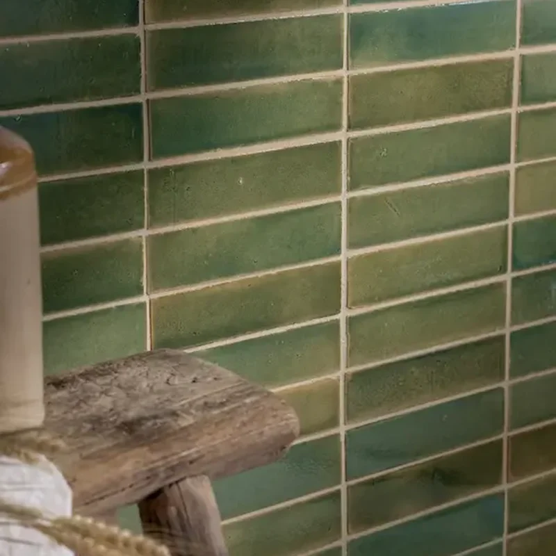 Stone Glaze Ceramic Olive Leaf Tile 5x20cm in gloss finish, laid in horizontal brick bond, styled with rustic stool and jar