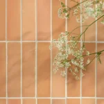 Stone Glaze Ceramic Petal Tile 5x20cm in gloss finish, laid in vertical brick bond, styled with delicate flowers