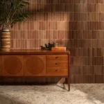 Stone Glaze Ceramic Tan 5x20cm wall tiles in a vertical brick layout, styled with mid-century furniture and terrazzo flooring