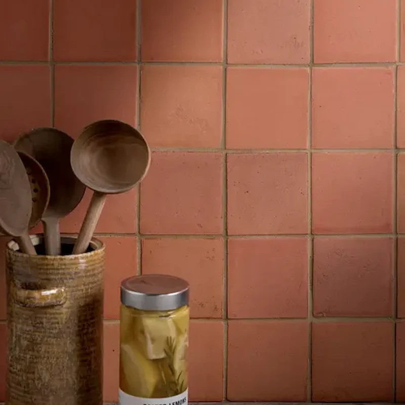 Close-up view of Terra Matt 10x10cm square ceramic wall tiles showing their natural matt texture and earthy tone