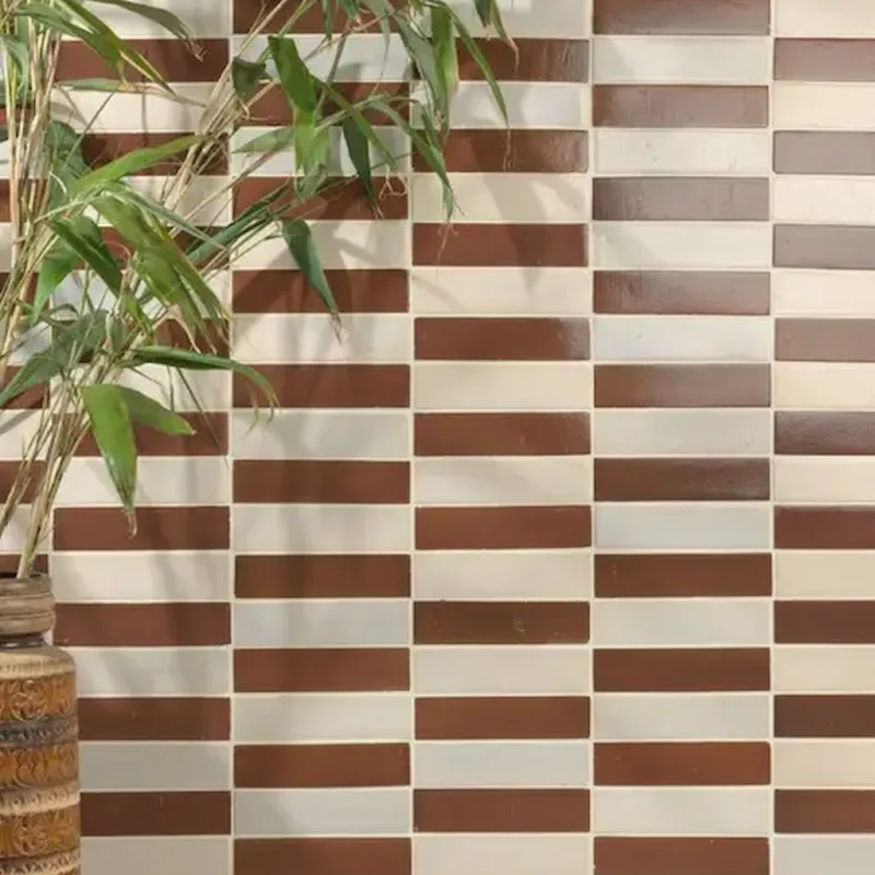 Stone Glaze Cola 5x20cm ceramic tiles styled in a mixed layout with neutral shades, creating a striking patterned wall.