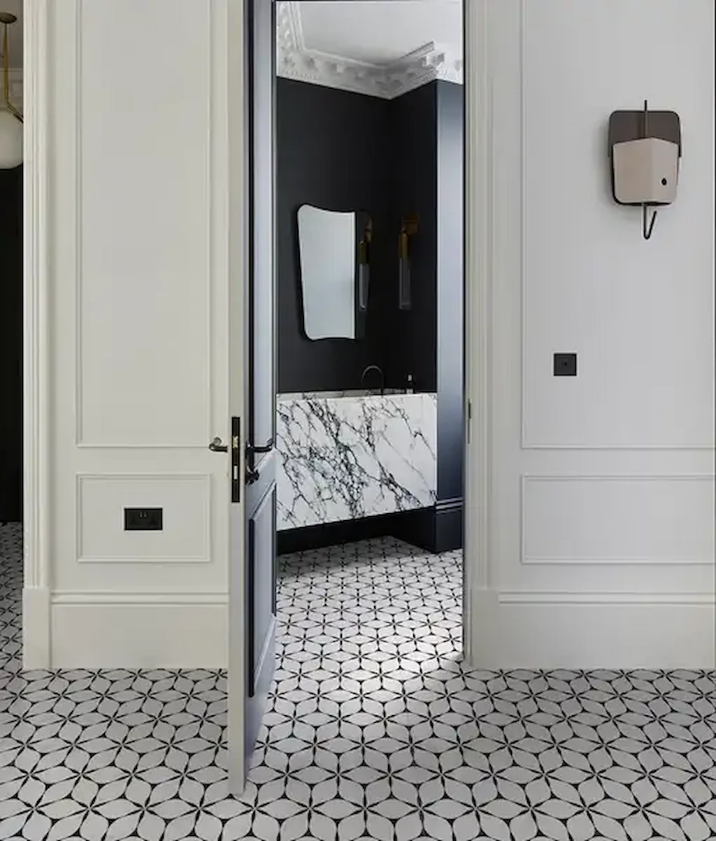 Bathroom and hallway with Byzantine Elysium porcelain floor tiles in a black and white geometric pattern