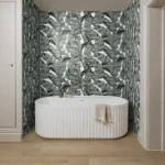 athroom feature wall with Byzantine Palmette porcelain tiles in a tropical leaf design behind a white freestanding bath
