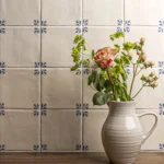 Classic Delft Cornelia wall tiles in cream with blue pattern, artisan glazed ceramic splashback for country kitchen interiors