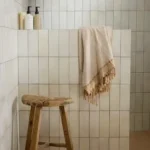Fontenay Porcelain Metro tiles in a soft beige shade, shown in a bathroom with vertical and horizontal layouts