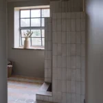 Fontenay Porcelain Pleated Tile used on a walk-in shower wall in a modern neutral bathroom