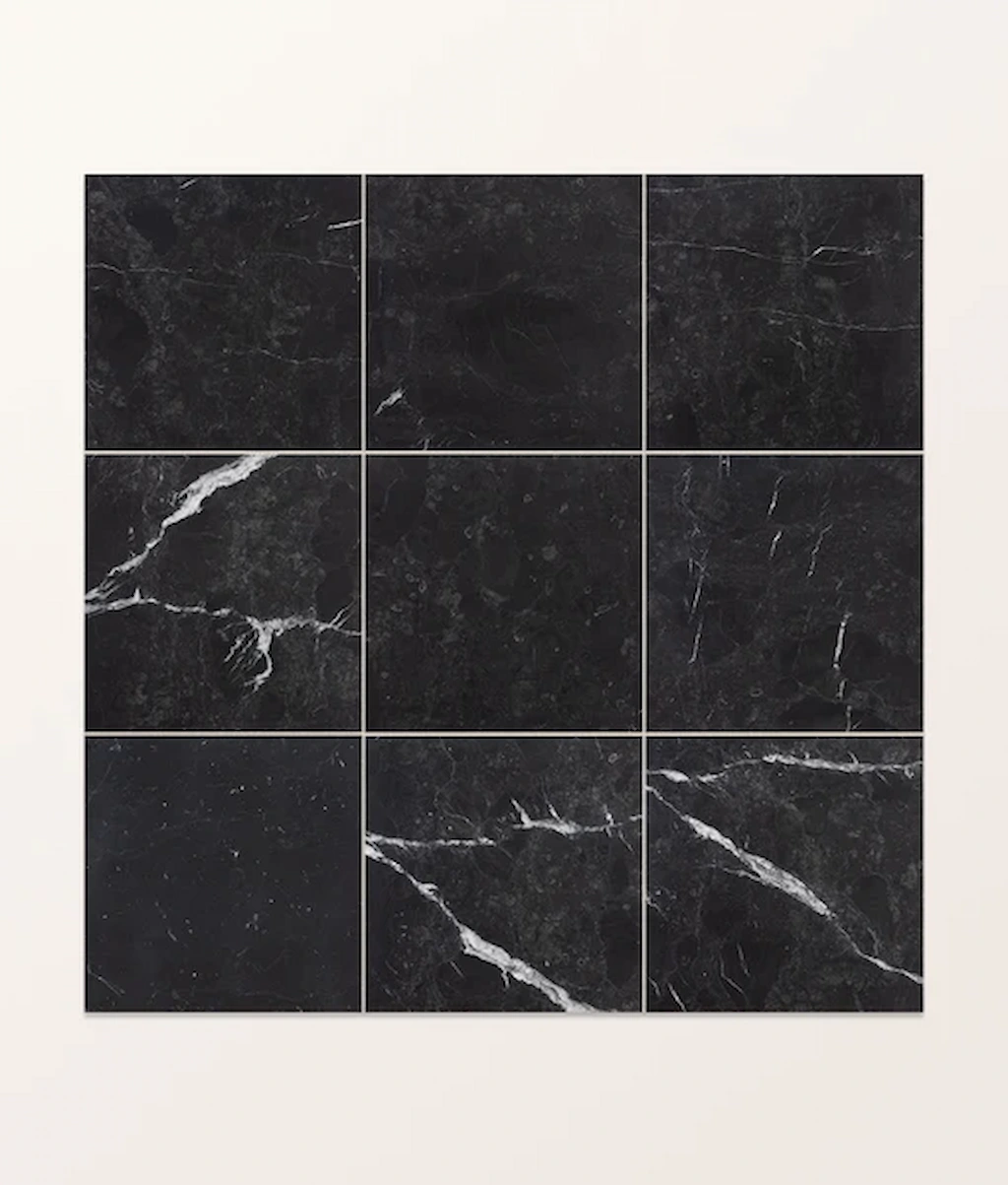 Versailles Marble Noir tile layout showing the dark marble surface with natural white veining and variation.