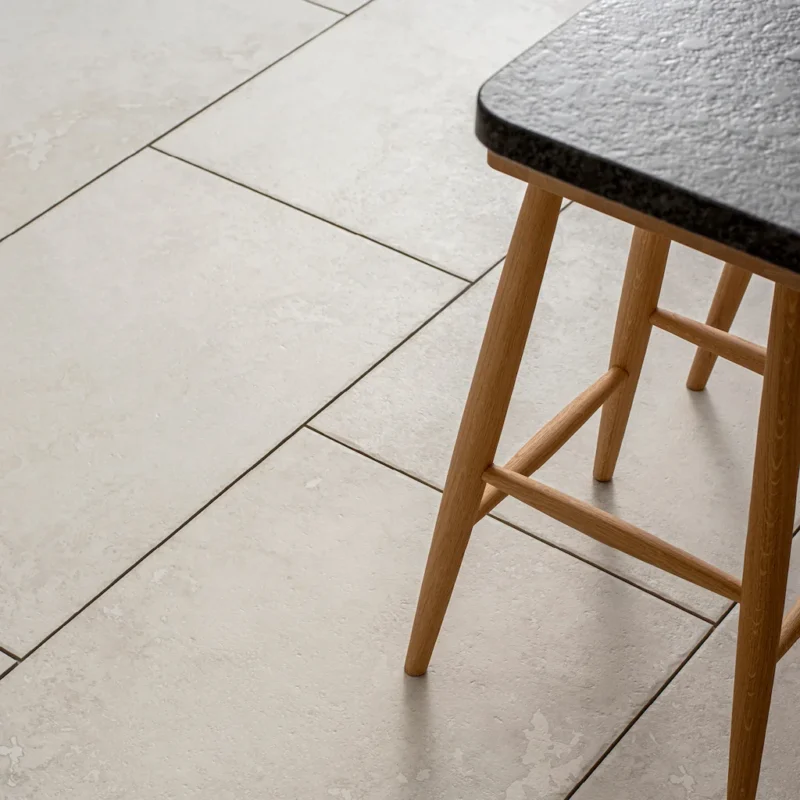 Close-up of Hartland Priory porcelain floor tiles showing soft stone texture and natural variation