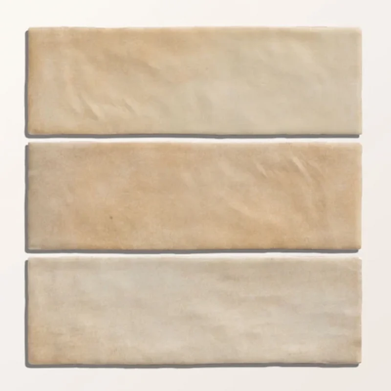 Oasis Veloute Ceramic Sand tiles shown individually, highlighting subtle tonal movement in warm sand shades and a smooth matt ceramic surface.