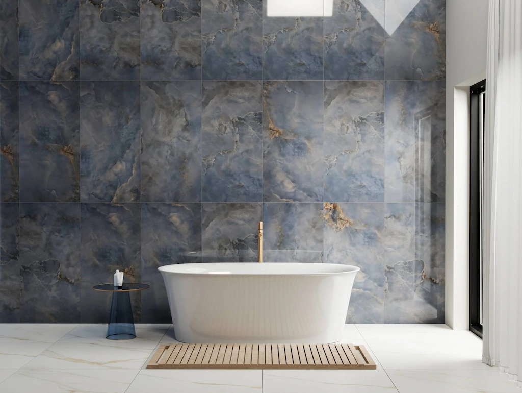 Aquamarine blue porcelain tiles in a modern bathroom with freestanding bath and marble-effect wall tiles