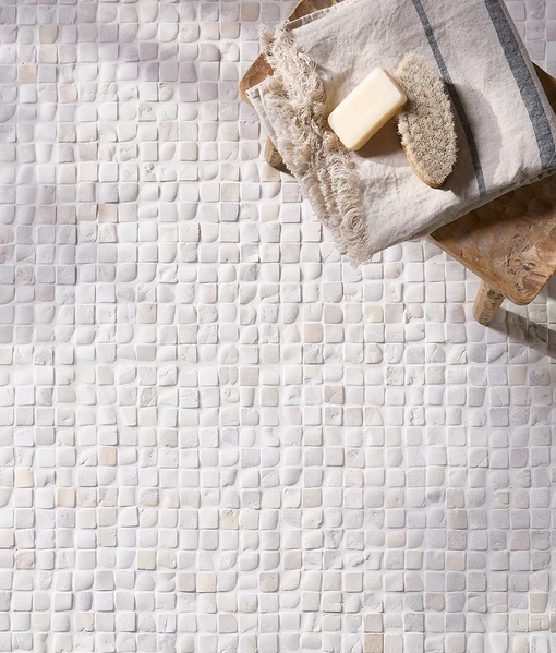 Enso Cobble Mosaic Cube Chalk 30x30cm tiles, small rounded limestone mosaic in soft chalk tones, natural textured bathroom surface with towel and soap