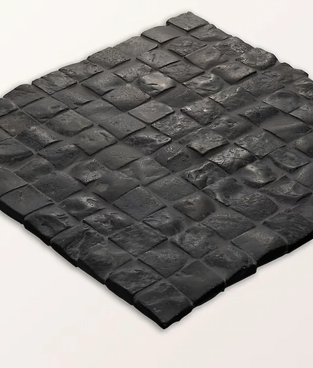 Enso Cobble Cube Charcoal small-format mosaic tiles in charcoal tones with a tumbled, natural stone look and varied texture, laid in a cobble-style pattern.