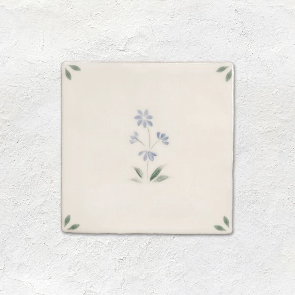 Spring Alice decorative ceramic tile from the Original Style Spring collection featuring a soft blue flower design on an off-white gloss tile.