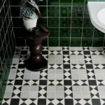 Olive green victorian style skirting tile shown on a bathroom wall with coordonating field tile