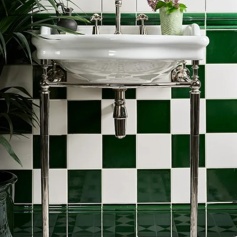 Olive green victorian style tile shown on a bathroom wall with white tile and skirting