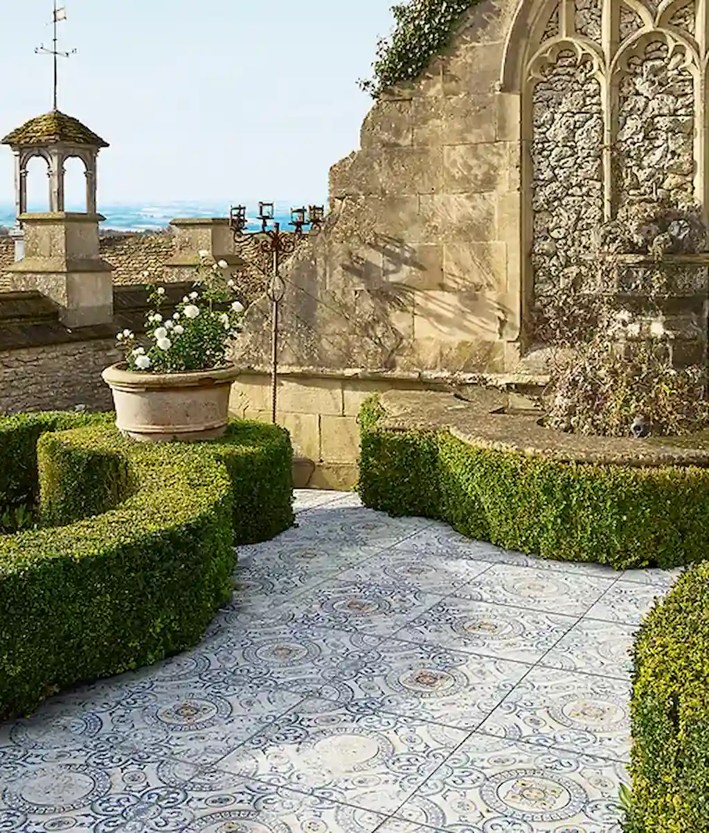 Close-up detail of Tapestry Porcelain Paving textured geometric tile with distressed blue and cream pattern finish.