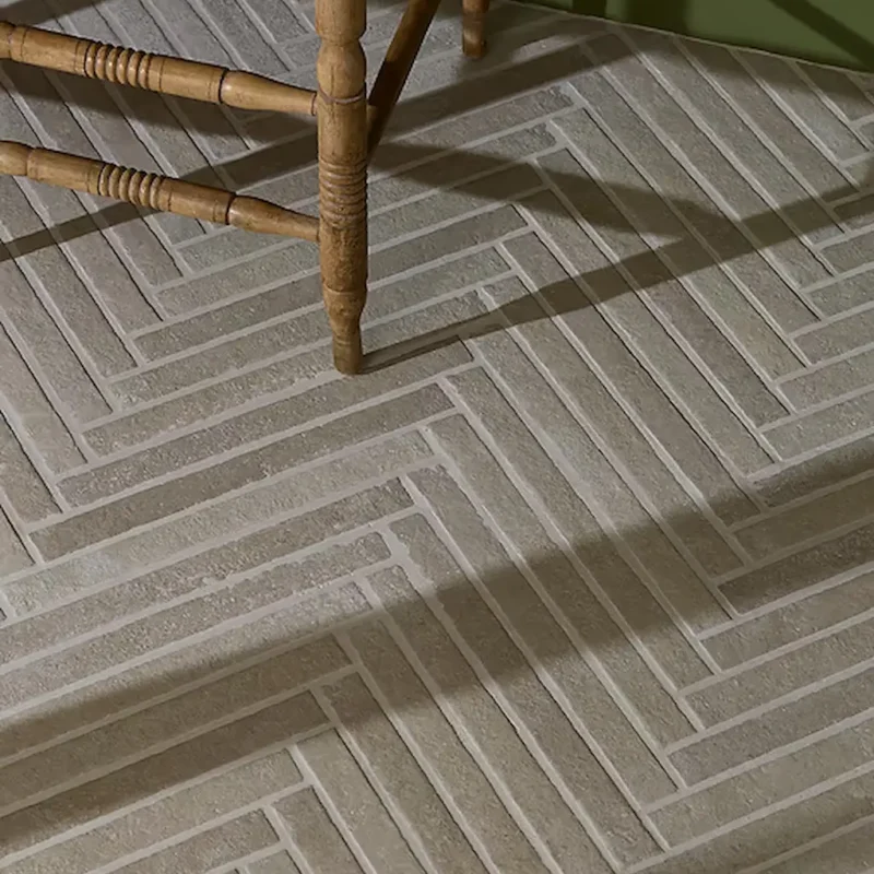 Close-up of Abbey Porcelain Parquet Blend porcelain parquet tiles by Ca' Pietra showing the detailed herringbone floor pattern.